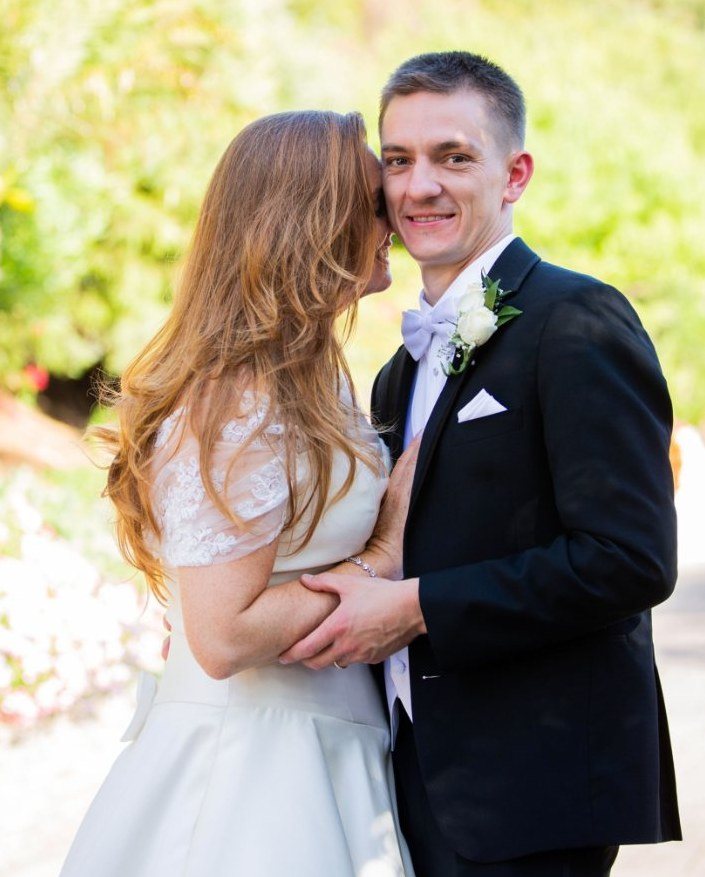 Couple embracing in a sunny garden