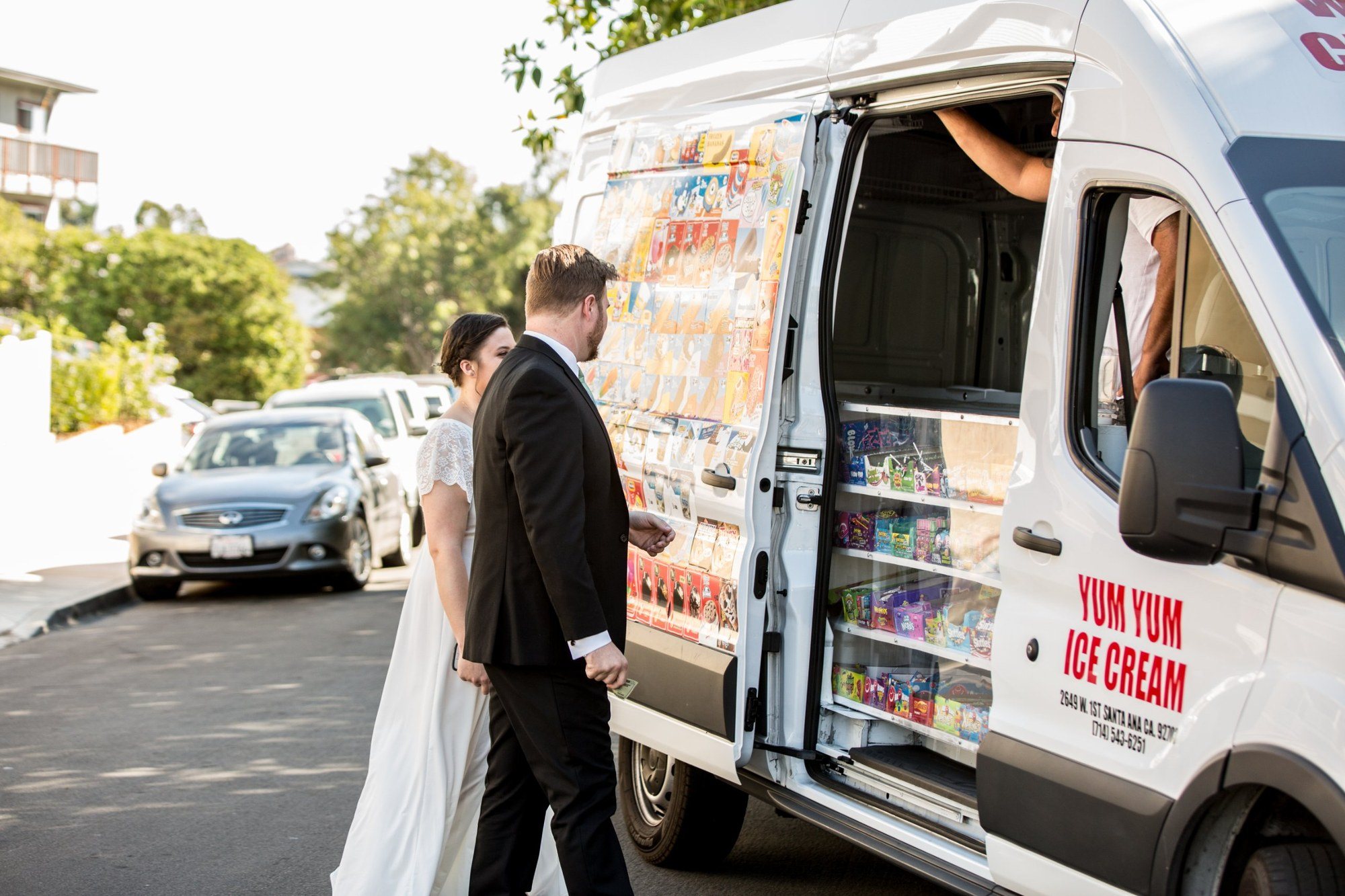 Bride and groom stopping at an ice cream truck after the ceremony
