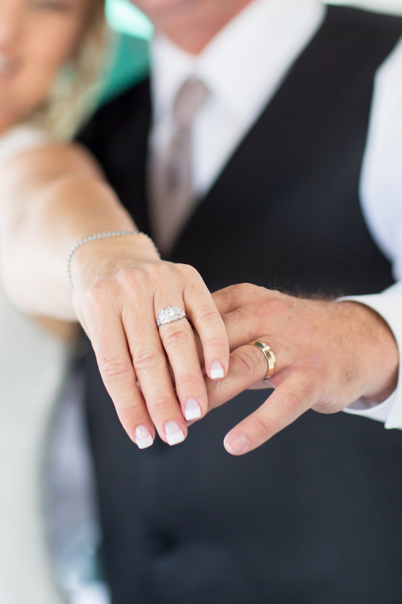 Bride and groom showing their wedding rings