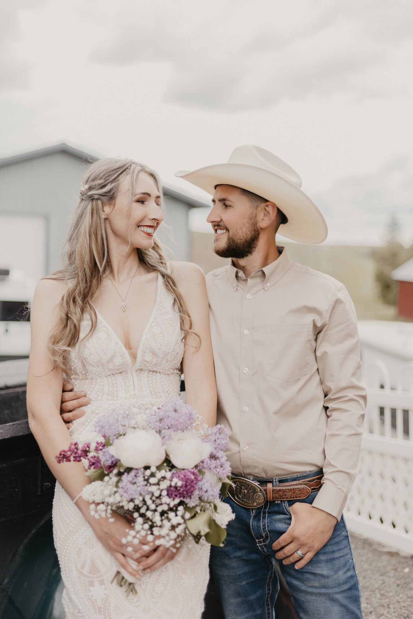 Bride and groom leaning on a vintage pickup truck
